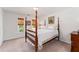 Bright bedroom featuring a four-poster bed and natural light at 205 Wellesley Ct, Woodstock, GA 30189