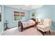 Cozy bedroom with a single bed, accent chair, and natural light from a window at 205 Wellesley Ct, Woodstock, GA 30189