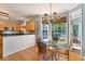 Eat-in kitchen featuring wood cabinets, stainless appliances, and large windows that provide abundant natural light at 205 Wellesley Ct, Woodstock, GA 30189