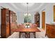 Formal dining room featuring a large wooden table, china cabinets, and elegant chandelier at 205 Wellesley Ct, Woodstock, GA 30189