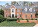 Stunning two-story brick home with a manicured front yard and classic architectural details at 205 Wellesley Ct, Woodstock, GA 30189