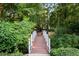 Charming footbridge surrounded by lush greenery offers a serene escape in the community at 205 Wellesley Ct, Woodstock, GA 30189