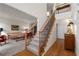 Open and inviting entry foyer with hardwood floors, stairway, and access to living room at 205 Wellesley Ct, Woodstock, GA 30189