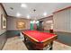 Spacious game room with vintage pool table, decorative lighting, and patterned wallpaper at 205 Wellesley Ct, Woodstock, GA 30189