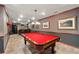 Game room with a red pool table and bar area offers a vintage and entertaining space at 205 Wellesley Ct, Woodstock, GA 30189