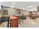 Recreation room featuring a red pool table and bar area with decorative lighting fixtures at 205 Wellesley Ct, Woodstock, GA 30189