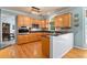 Well-lit kitchen featuring wood cabinets, granite counters, stainless steel appliances, and a raised breakfast bar at 205 Wellesley Ct, Woodstock, GA 30189