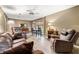 Inviting living room with recliner seating, tile floors, ceiling fan, and natural light at 205 Wellesley Ct, Woodstock, GA 30189