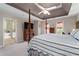 Spacious main bedroom featuring a four-poster bed, tray ceiling, and an ensuite bathroom entrance at 205 Wellesley Ct, Woodstock, GA 30189