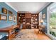 Bright office featuring wood built-ins, a large window, desk, and a patterned area rug at 205 Wellesley Ct, Woodstock, GA 30189
