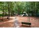 Community playground with swings, slide, and benches provides outdoor fun for residents at 205 Wellesley Ct, Woodstock, GA 30189