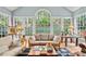 Sunroom with large windows offering beautiful views of the surrounding greenery at 205 Wellesley Ct, Woodstock, GA 30189