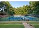 Enjoy a match at the community's well-maintained tennis courts surrounded by lush greenery and featuring a covered viewing area at 205 Wellesley Ct, Woodstock, GA 30189