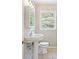 Cozy bathroom with tile floors, single pedestal sink, and a bright window with private outdoor view at 2125 Perkerson Mill Rd, Austell, GA 30106
