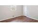Neutral bedroom featuring hardwood floors, one bright window, baseboard heat, and neutral walls at 2125 Perkerson Mill Rd, Austell, GA 30106