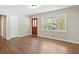 Inviting entryway with beautiful front door, and hardwood floors, next to a large picture window at 2125 Perkerson Mill Rd, Austell, GA 30106