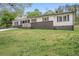 Well-maintained home features a freshly painted exterior, a carport, and mature trees at 2125 Perkerson Mill Rd, Austell, GA 30106