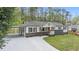 Inviting home featuring fresh exterior paint, a carport, and a long, updated driveway at 2125 Perkerson Mill Rd, Austell, GA 30106