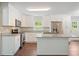 Modern kitchen with granite countertops, island, stainless steel appliances, and white cabinetry at 2125 Perkerson Mill Rd, Austell, GA 30106