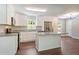Bright kitchen features white cabinets, stainless steel appliances and a center island with granite countertops at 2125 Perkerson Mill Rd, Austell, GA 30106