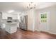 Modern kitchen with stainless steel refrigerator, white cabinets, granite countertops, and door to the backyard at 2125 Perkerson Mill Rd, Austell, GA 30106