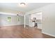 Open-concept living room with hardwood floors connecting the kitchen, dining, and living areas at 2125 Perkerson Mill Rd, Austell, GA 30106