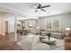 Open-concept living space with modern furnishings, hardwood flooring, and sun-filled windows at 2125 Perkerson Mill Rd, Austell, GA 30106
