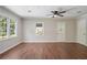 Bright living room featuring hardwood floors, a ceiling fan, and bright windows with a private view at 2125 Perkerson Mill Rd, Austell, GA 30106
