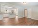 Open-concept living room with hardwood floors, the kitchen is visible from the living room at 2125 Perkerson Mill Rd, Austell, GA 30106