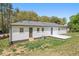 The home's rear exterior features a small patio and multiple entry doors with a yard at 2125 Perkerson Mill Rd, Austell, GA 30106