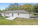 The rear exterior features white siding, a gray roof, a small patio, and a covered parking area at 2125 Perkerson Mill Rd, Austell, GA 30106