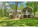 Spacious backyard featuring a screened-in porch and mature shade trees at 2488 Glendale Se Cir, Smyrna, GA 30080