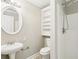Bathroom featuring a pedestal sink, large mirror, and a shower with white tile surround at 2488 Glendale Se Cir, Smyrna, GA 30080