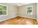 Bedroom with wood floors, white trim, neutral walls, and windows that let in natural light at 2488 Glendale Se Cir, Smyrna, GA 30080