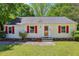Charming home with vibrant red shutters and well-manicured front yard at 2488 Glendale Se Cir, Smyrna, GA 30080