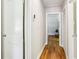 Hallway with wood floors and view to the bedroom, a bench and art at 2488 Glendale Se Cir, Smyrna, GA 30080