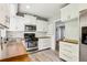 Bright kitchen featuring white cabinetry, stainless steel appliances, and butcher block countertops at 2488 Glendale Se Cir, Smyrna, GA 30080