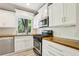 Modern kitchen featuring white cabinets, butcher block countertops, and stainless steel appliances at 2488 Glendale Se Cir, Smyrna, GA 30080