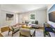 Bright living room boasts hardwood floors, neutral paint, modern furniture, and a view of the front yard at 2488 Glendale Se Cir, Smyrna, GA 30080