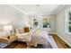 Inviting primary bedroom with hardwood floors, neutral walls, two windows, and a stylish light fixture at 2488 Glendale Se Cir, Smyrna, GA 30080