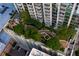 Aerial view of a high-rise building with lush rooftop gardens, walkways, seating and a water feature at 855 Peachtree Ne St # 2706, Atlanta, GA 30308