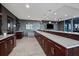 Modern bar area with long countertops, stylish cabinetry, and a TV at 855 Peachtree Ne St # 2706, Atlanta, GA 30308