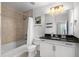 Clean bathroom featuring a shower-tub combo, vanity, and stylish lighting offers a functional space at 855 Peachtree Ne St # 2706, Atlanta, GA 30308
