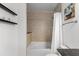 Close up of a neutral-toned bathroom featuring a shower-tub combo, vanity, and stylish lighting at 855 Peachtree Ne St # 2706, Atlanta, GA 30308