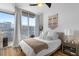 Inviting bedroom has a comfortable bed, modern decor, and large windows with access to a balcony and city views at 855 Peachtree Ne St # 2706, Atlanta, GA 30308