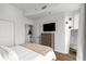 Bedroom with a large window, TV, and dresser offers a comfortable retreat for relaxation and rest at 855 Peachtree Ne St # 2706, Atlanta, GA 30308