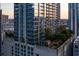 Stunning high-rise building with modern architecture, glass balconies, and a rooftop terrace with a pool at 855 Peachtree Ne St # 2706, Atlanta, GA 30308