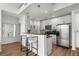 Modern kitchen featuring white cabinetry, stainless steel appliances, and a breakfast bar with seating at 855 Peachtree Ne St # 2706, Atlanta, GA 30308