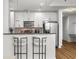 Bright kitchen features white cabinets, granite counters, stainless appliances, and a breakfast bar with bar stools at 855 Peachtree Ne St # 2706, Atlanta, GA 30308