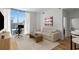Open concept living room with floor-to-ceiling windows, a comfortable sofa, and modern decor at 855 Peachtree Ne St # 2706, Atlanta, GA 30308